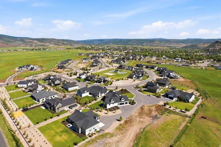 Expansive residential development featuring a collection of modern homes with dark asphalt shingle roofs
