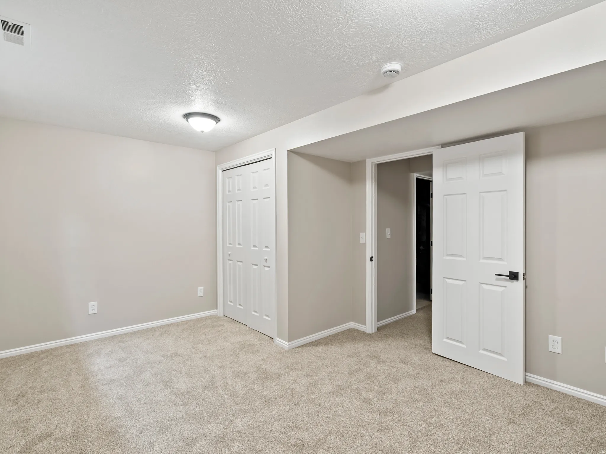 Neutral tone-on-tone carpeting throughout