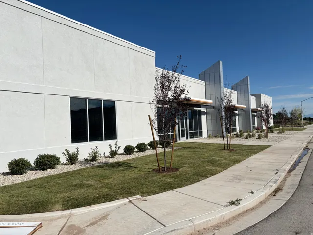 Contemporary commercial exterior featuring a stucco facade and expansive windows