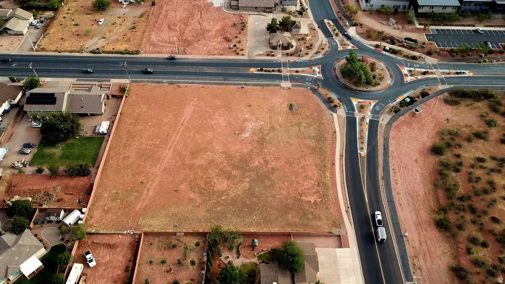 Expansive undeveloped lot featuring a large, flat, red earth surface