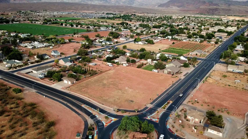 Aerial overview showcasing a developed residential area with scattered mature trees and open land parcels