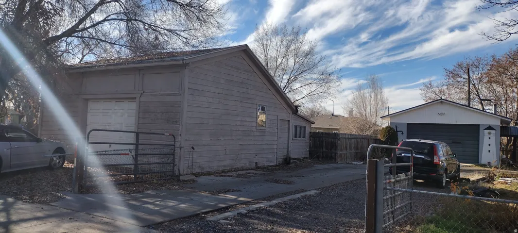 Detached garage featuring panel siding and a roll-up door