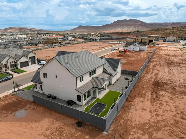 Contemporary residence with a gray tile roof and white exterior