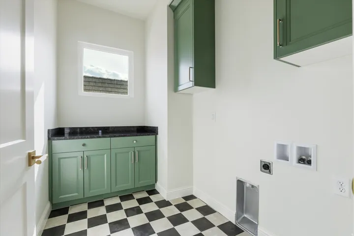 Green shaker-style cabinetry with gold-tone hardware