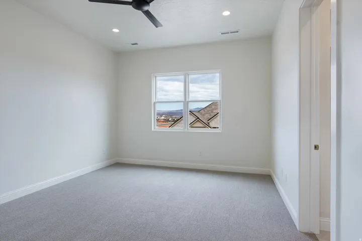 Spacious interior room with light gray carpet flooring