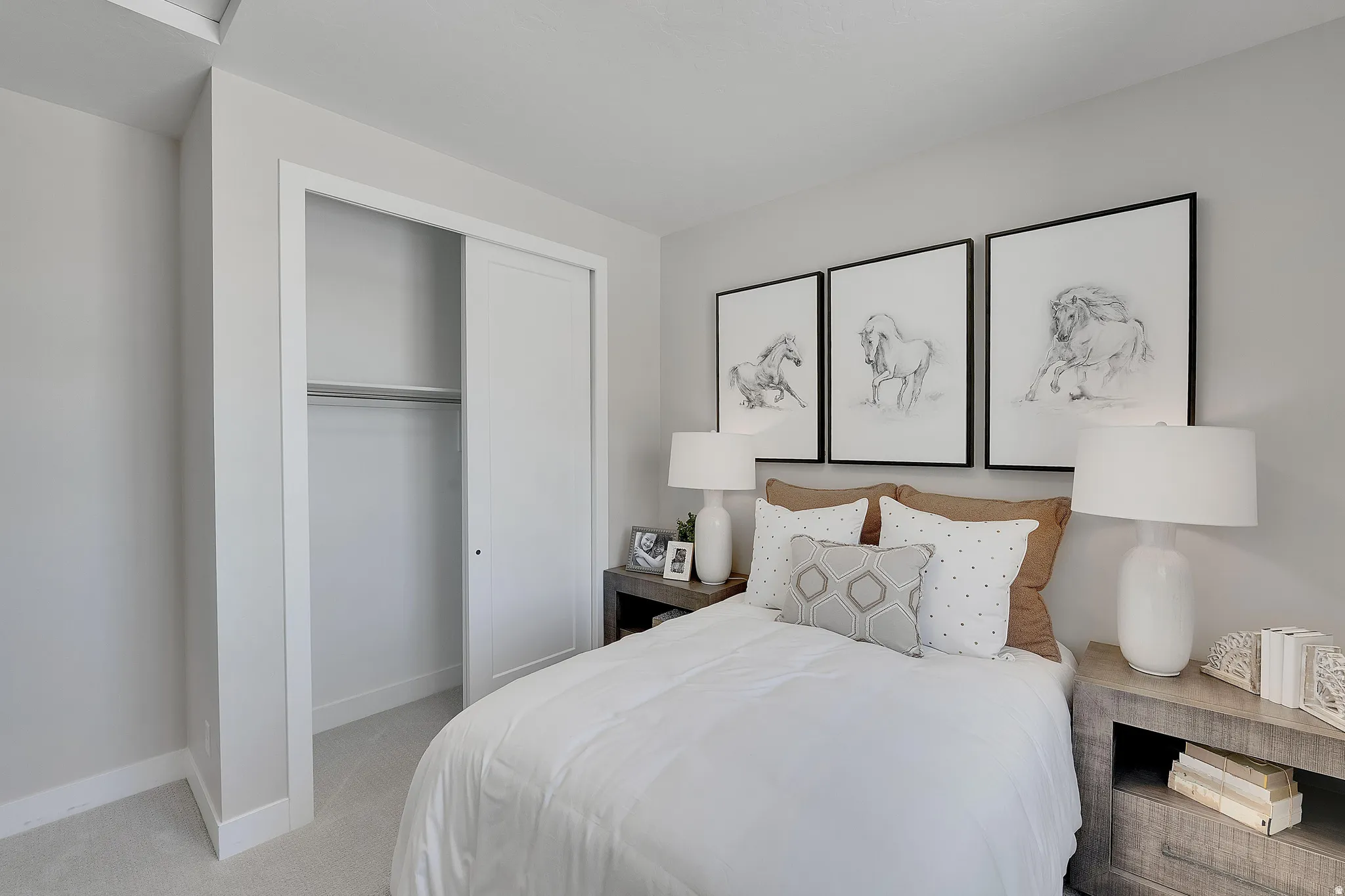 Bedroom featuring light gray wall paint, white trim, and light-toned carpet flooring. This is not the actual home being built but a representation of the features available in this home. Colors and finishes may differ from those shown.