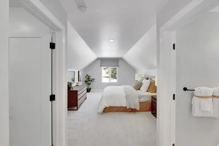Attic bedroom featuring pitched ceilings, recessed lighting, a window with a roller shade, and light-toned carpeting. This is not the actual home being built but a representation of the features available in this home. Colors and finishes may differ from