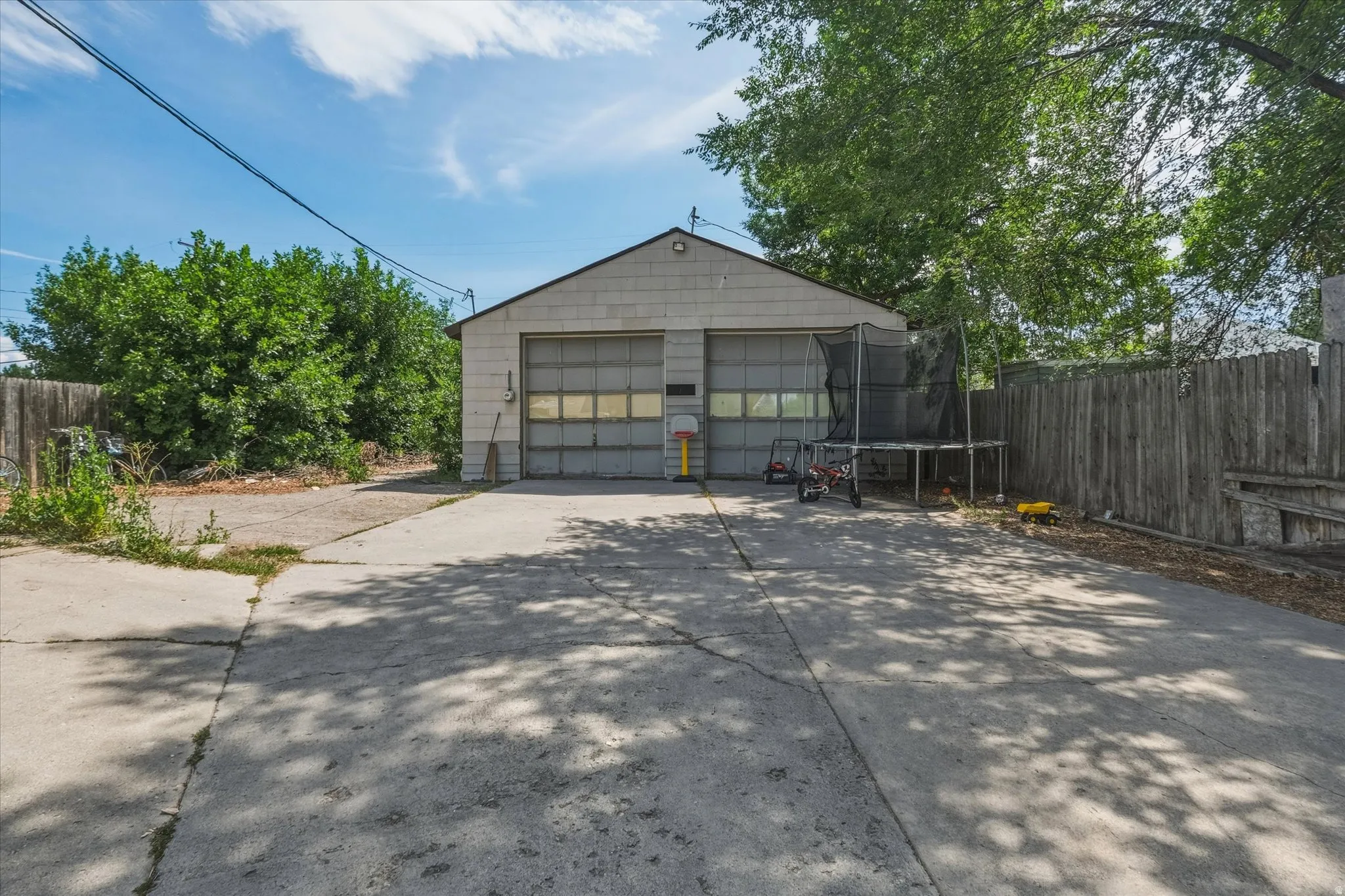 Two-car detached garage with panel doors and upper window inserts