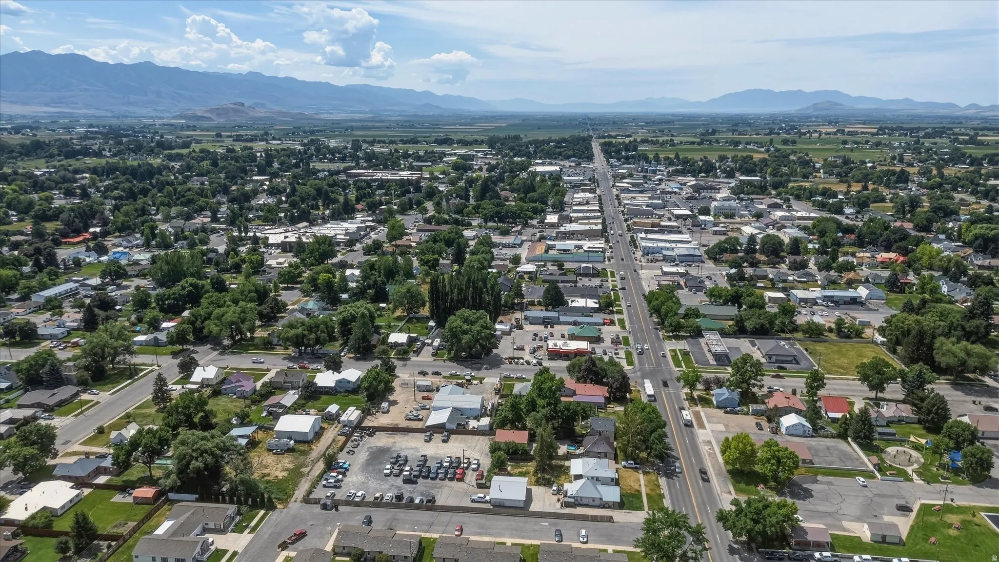 Aerial perspective showcasing a community with extensive green spaces and established tree canopy