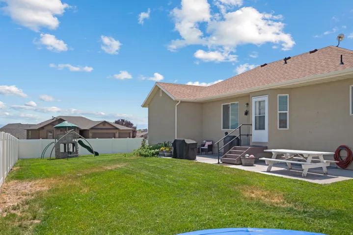 Expansive green lawn with a privacy fence