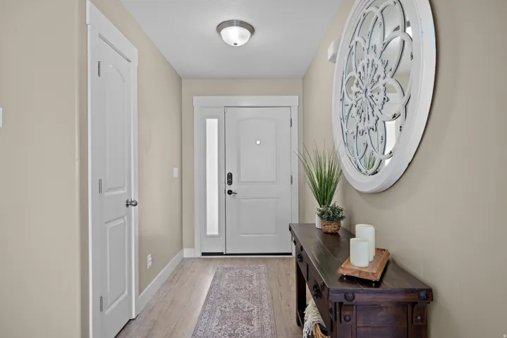 Entryway featuring wood-finish flooring, light beige walls, and a recessed ceiling light