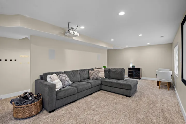 Spacious room featuring neutral carpeting and recessed lighting