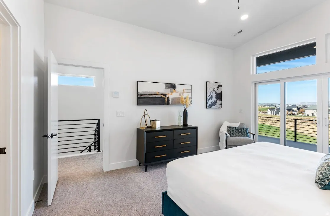 Bedroom featuring sliding glass doors, a transom window, and recessed lighting