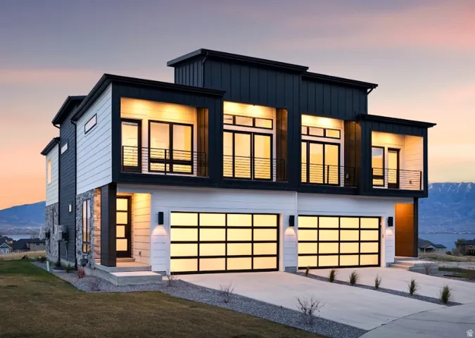 Contemporary exterior featuring a multi-tone facade with dark vertical siding, light horizontal siding, and stone accents