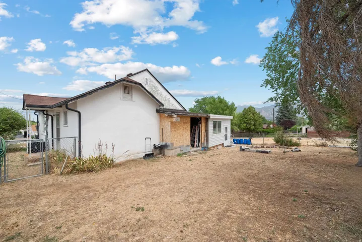 Expansive rear yard with a partially fenced area