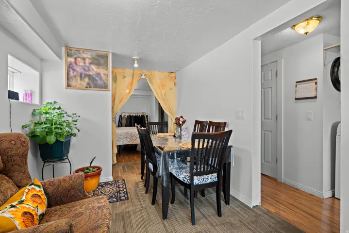 Dining area featuring a neutral color palette, carpet flooring, recessed lighting, and a doorway with wood-finish flooring