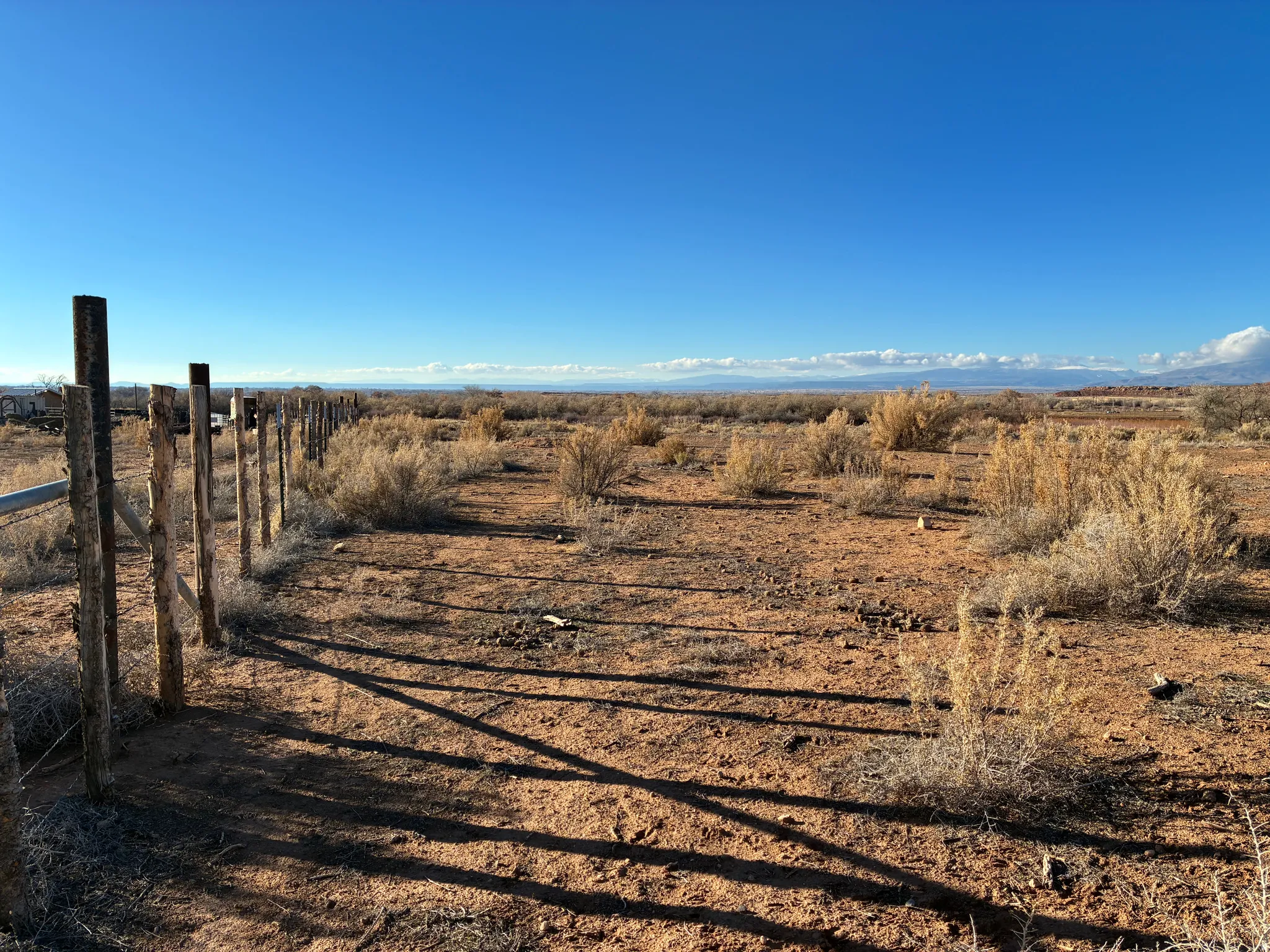 Expansive unimproved land with partial perimeter fencing