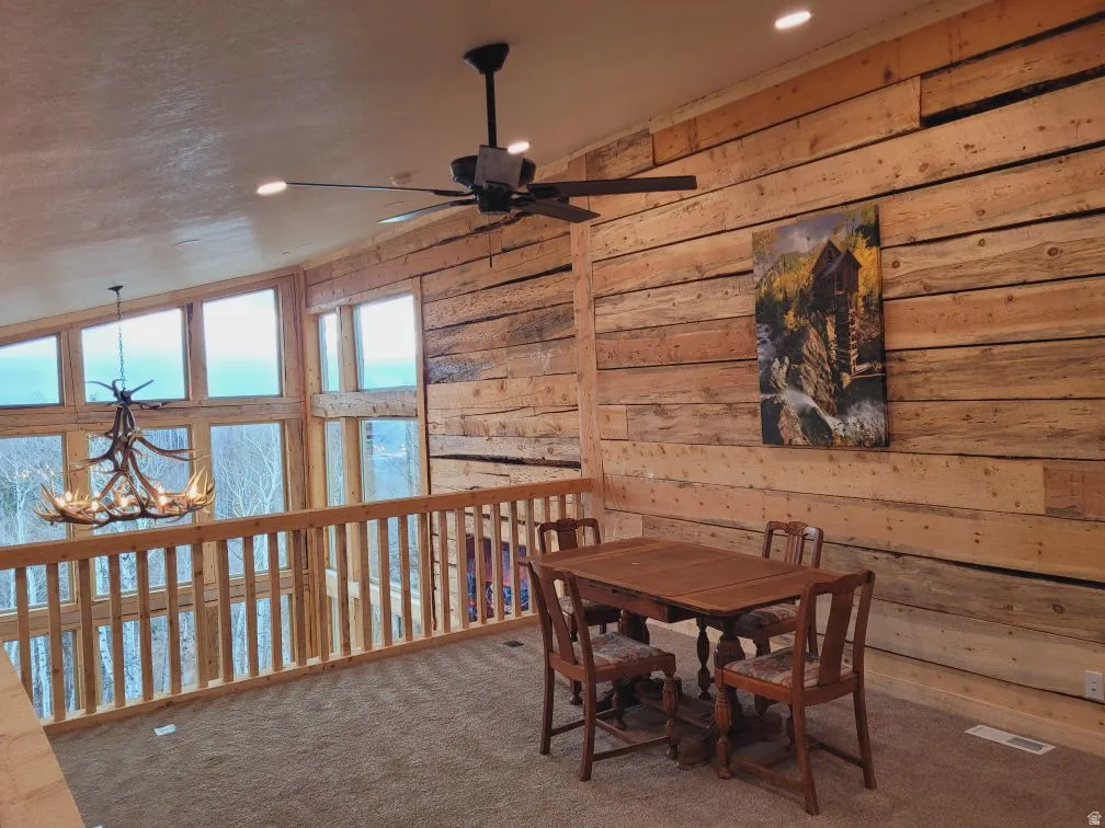 Rustic-style wall paneling and a light wood railing define this elevated space