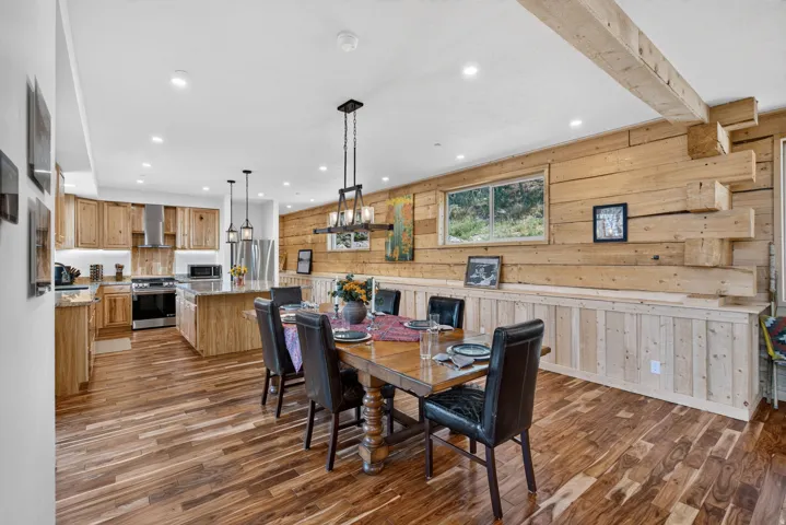 Open-concept dining area featuring wood-finish flooring