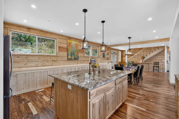 Kitchen island featuring a stone countertop and wood-finish cabinetry