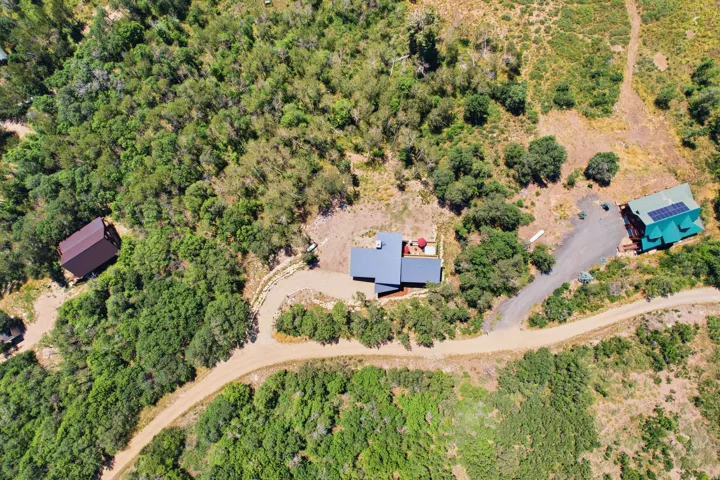 Aerial perspective showcasing multiple structures surrounded by extensive natural foliage