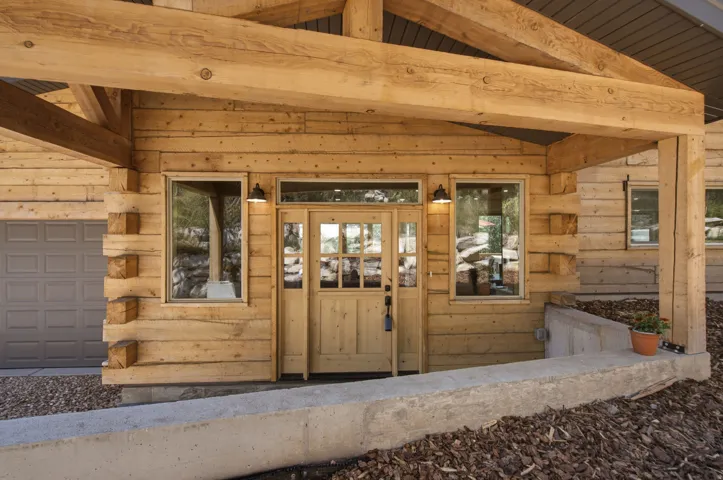 Crafted wood-plank exterior featuring a substantial timber frame entrance