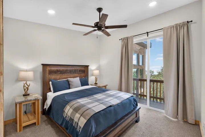 Bedroom featuring light gray walls, recessed lighting, and a dark-toned ceiling fan