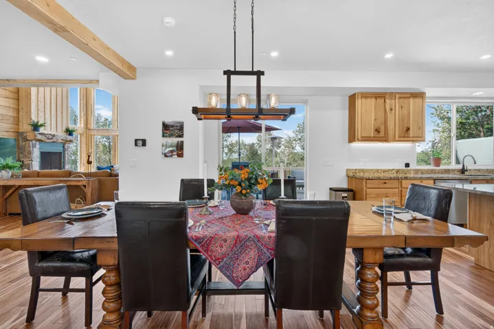 Sophisticated dining space showcasing a solid wood table with turned legs, paired with upholstered black dining chairs