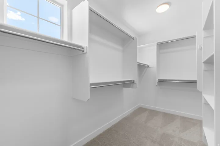 Built-in closet organization system with multiple shelves and hanging rods