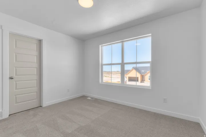 Neutral-toned carpeting with white walls and trim