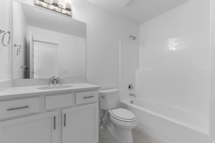 White vanity with an integrated sink, polished chrome faucet, and ample storage cabinetry