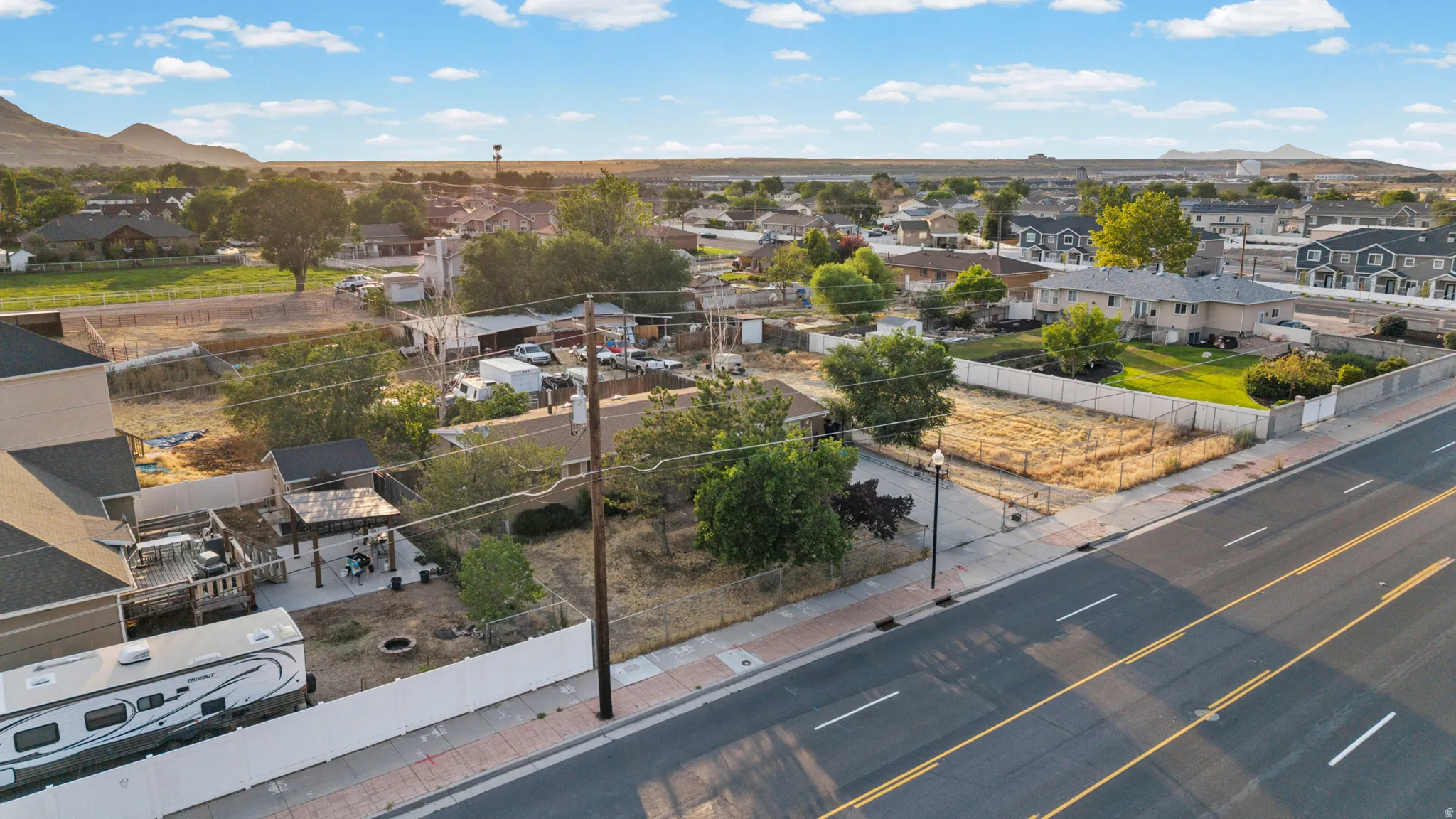 Expansive lot featuring street frontage, mature trees, and existing utility pole access