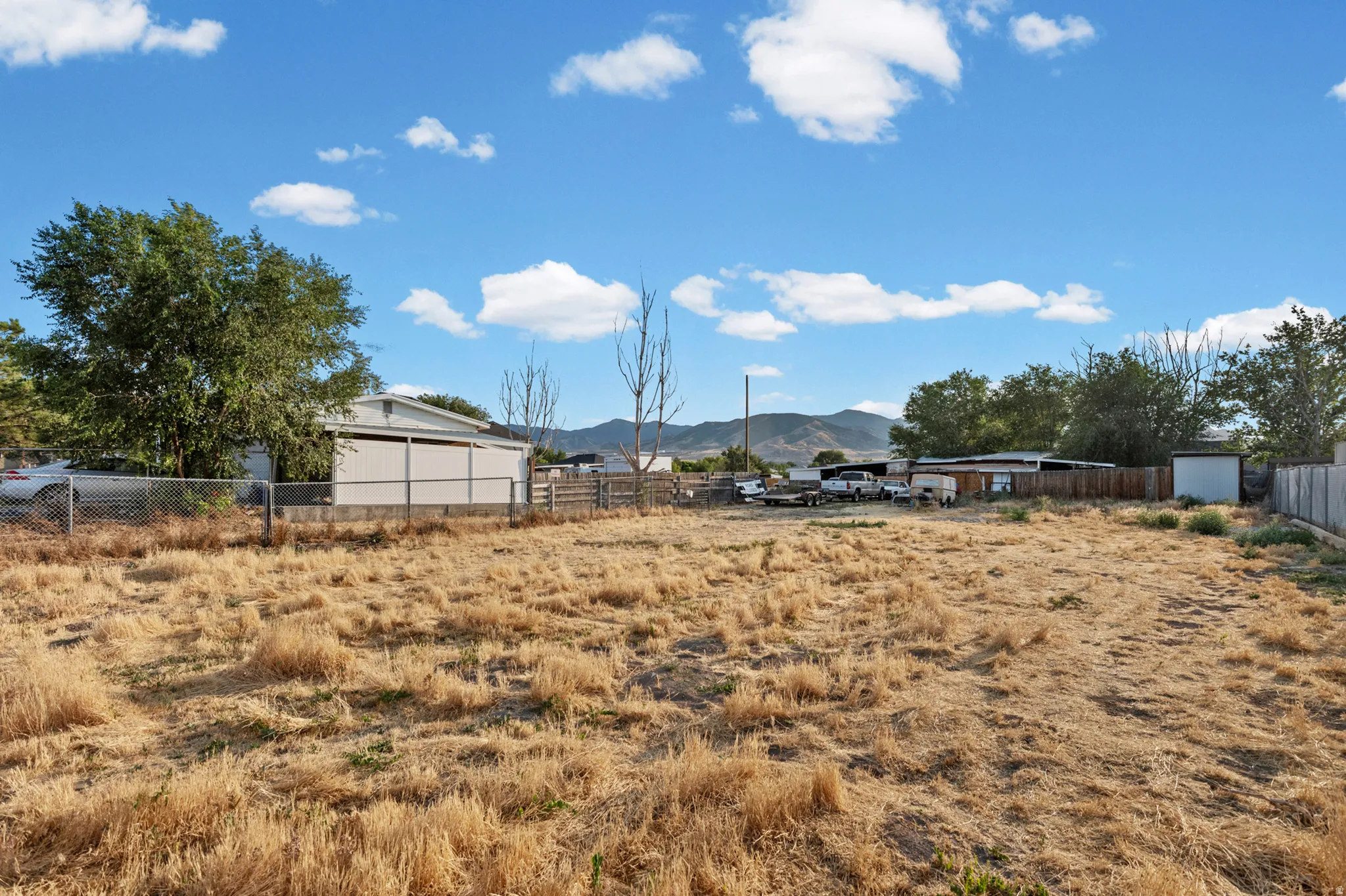 Expansive undeveloped lot with perimeter fencing