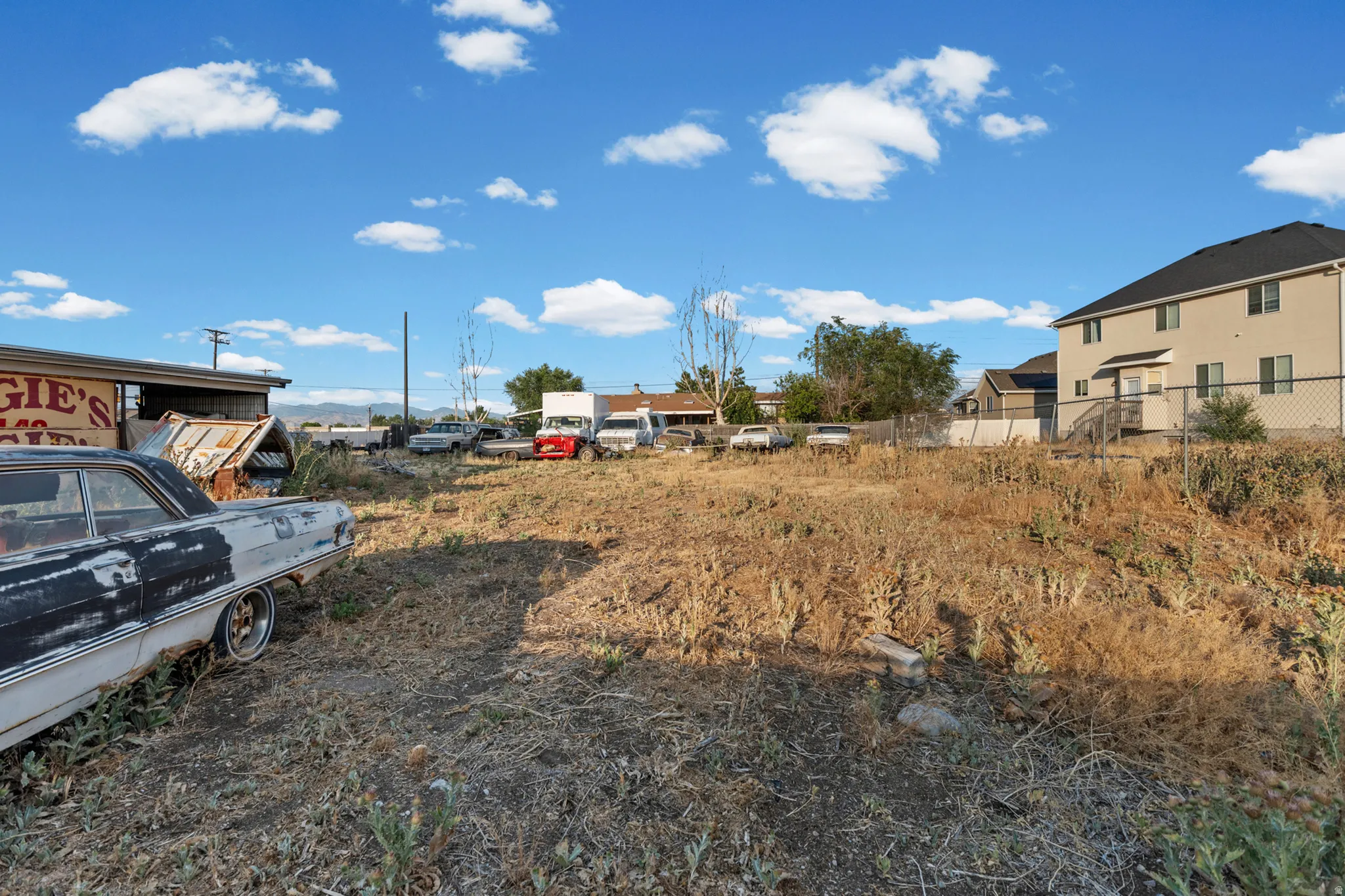 Expansive undeveloped lot with varied topography and established structures bordering the property