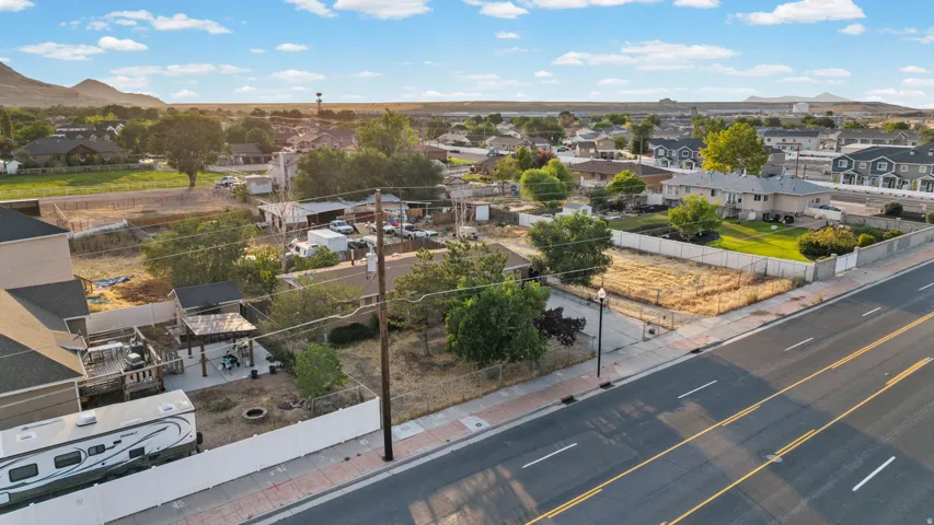 Expansive lot featuring street frontage, mature trees, and existing utility pole access