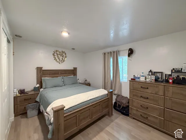 Bedroom featuring light wood-finish flooring and white painted walls