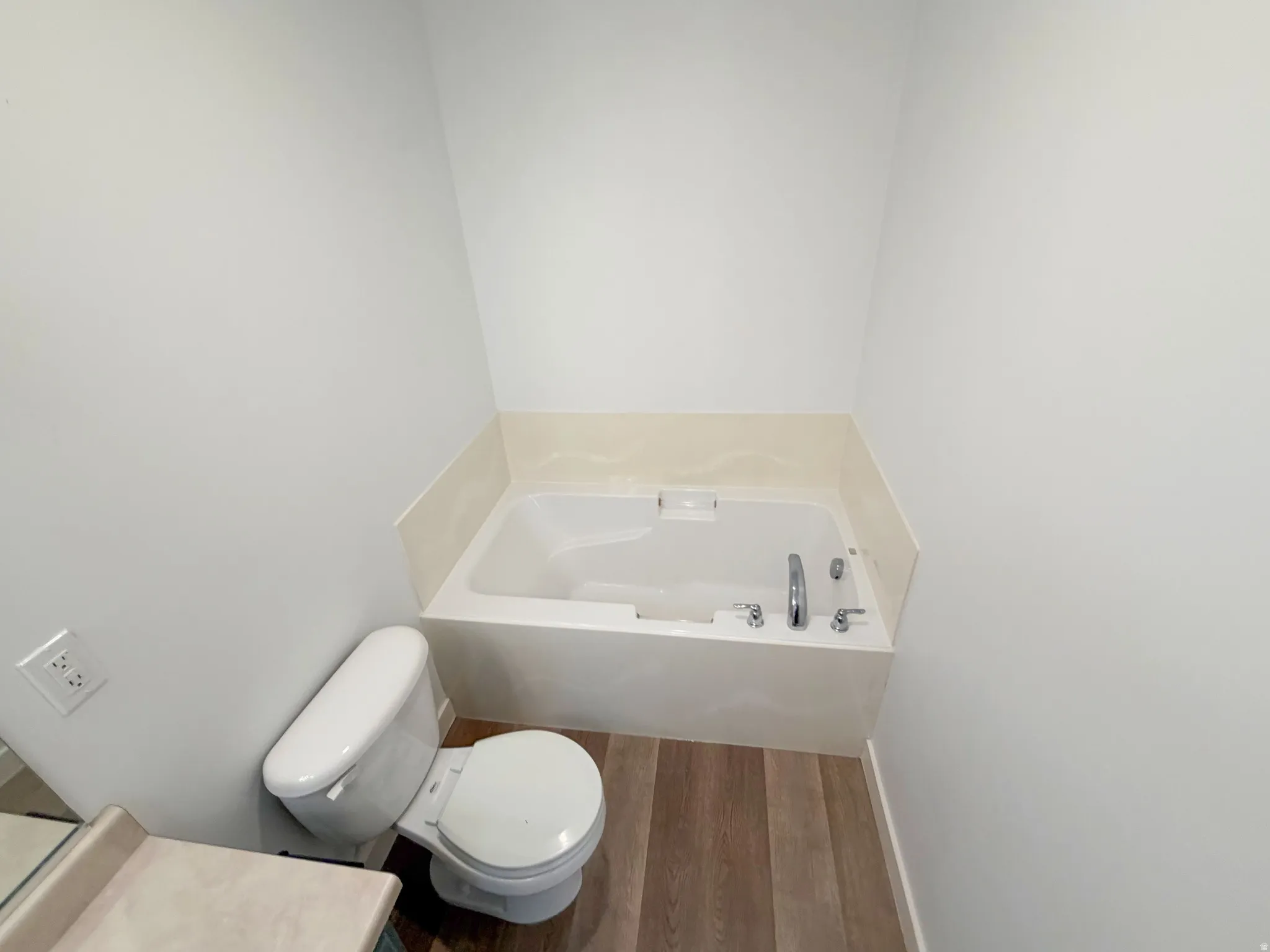 Drop-in bathtub with a tile surround and chrome fixtures