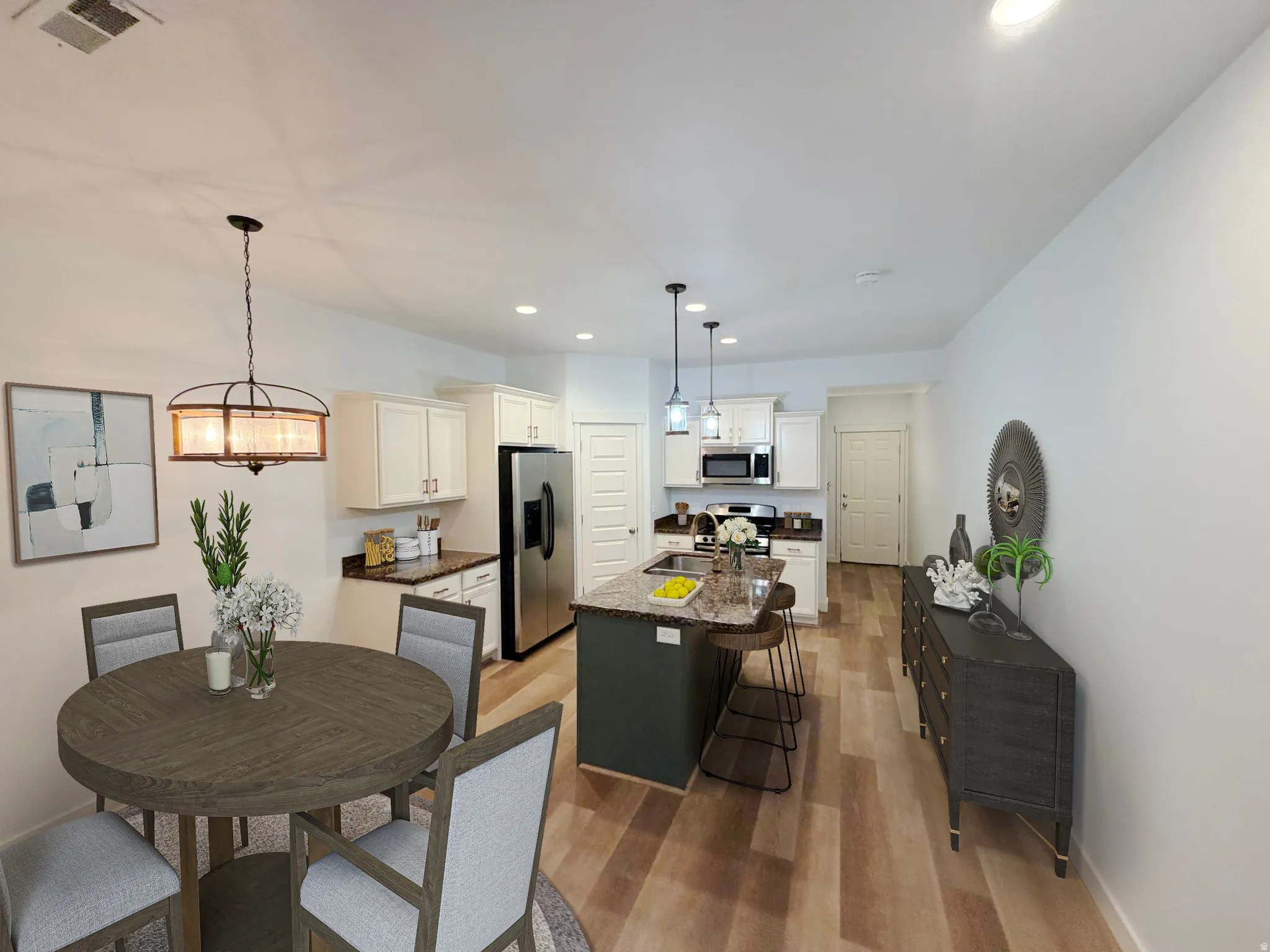 Open-concept living area featuring wood-finish flooring