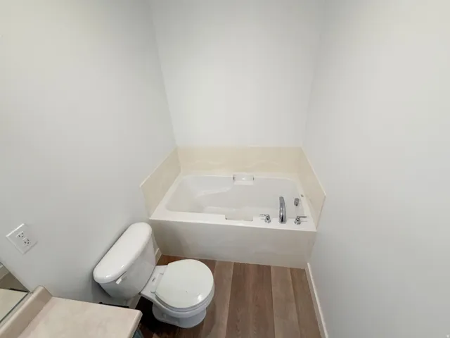 Drop-in bathtub with a tile surround and chrome fixtures