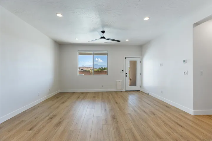 Open concept living space featuring wood-finish flooring, recessed lighting, and a modern ceiling fan