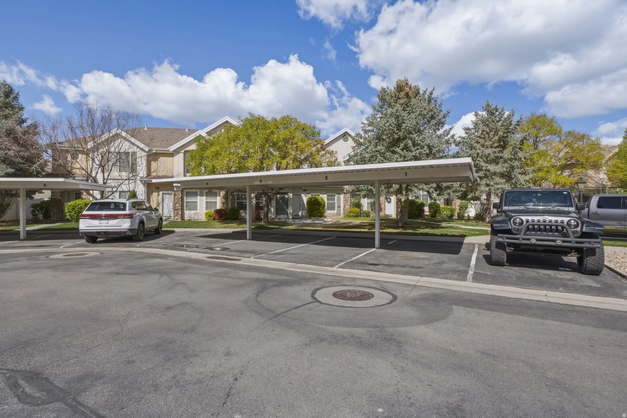 Carport parking spaces with assigned numbering offer covered parking