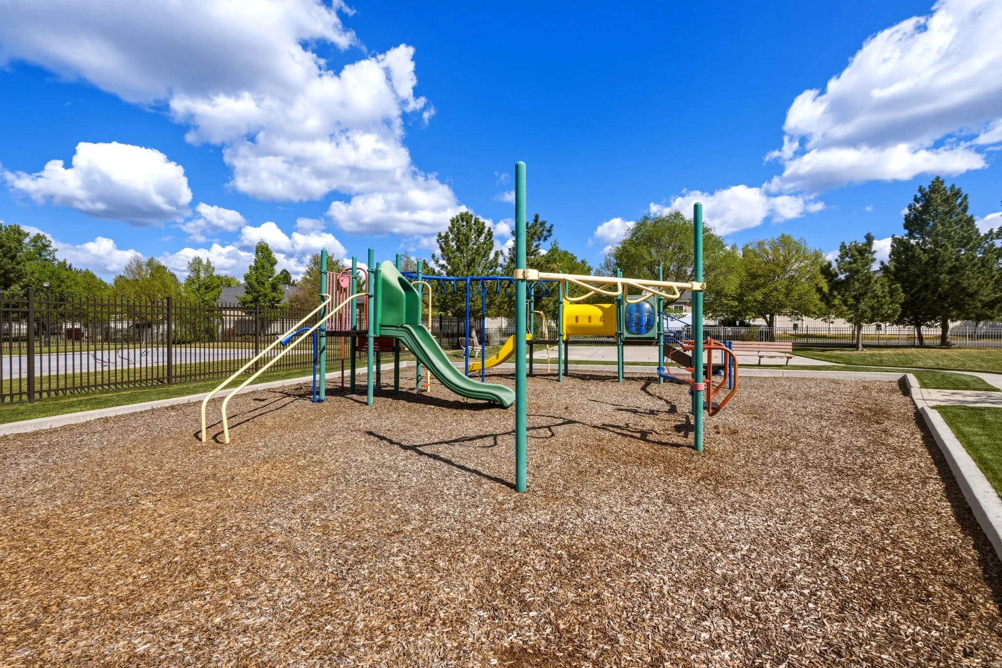 Community playground featuring a multi-level structure with slides and climbing elements