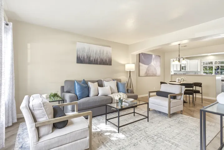 Living area featuring light-toned walls and wood-finish flooring