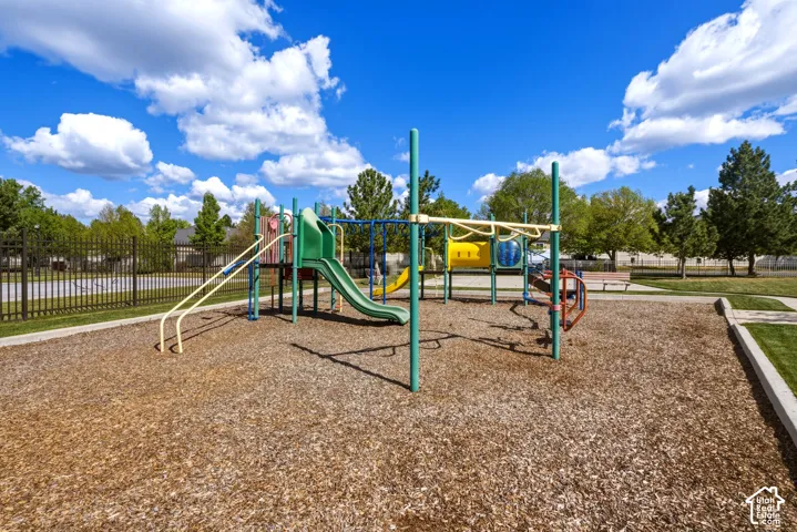 Community playground featuring a multi-level structure with slides and climbing elements