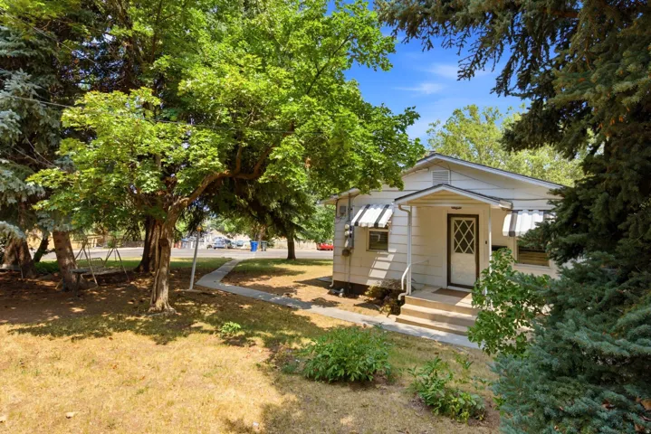White exterior with a covered porch entry featuring a decorative storm door