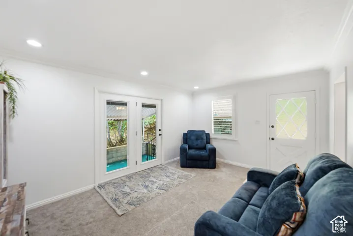 Spacious room featuring light gray carpet flooring, white walls, and recessed lighting