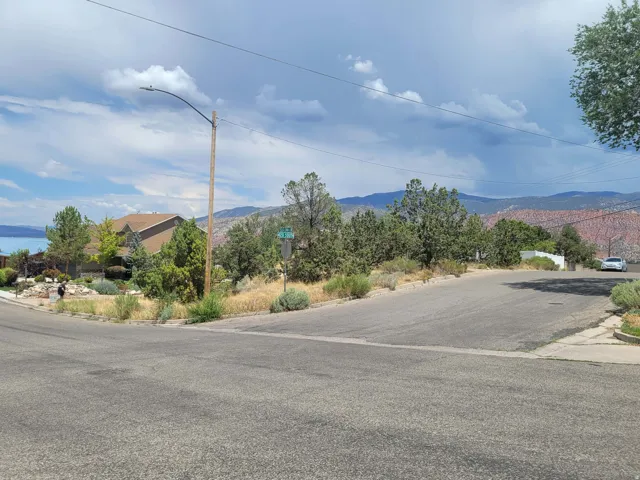 Corner lot location featuring mature natural landscaping and distant water