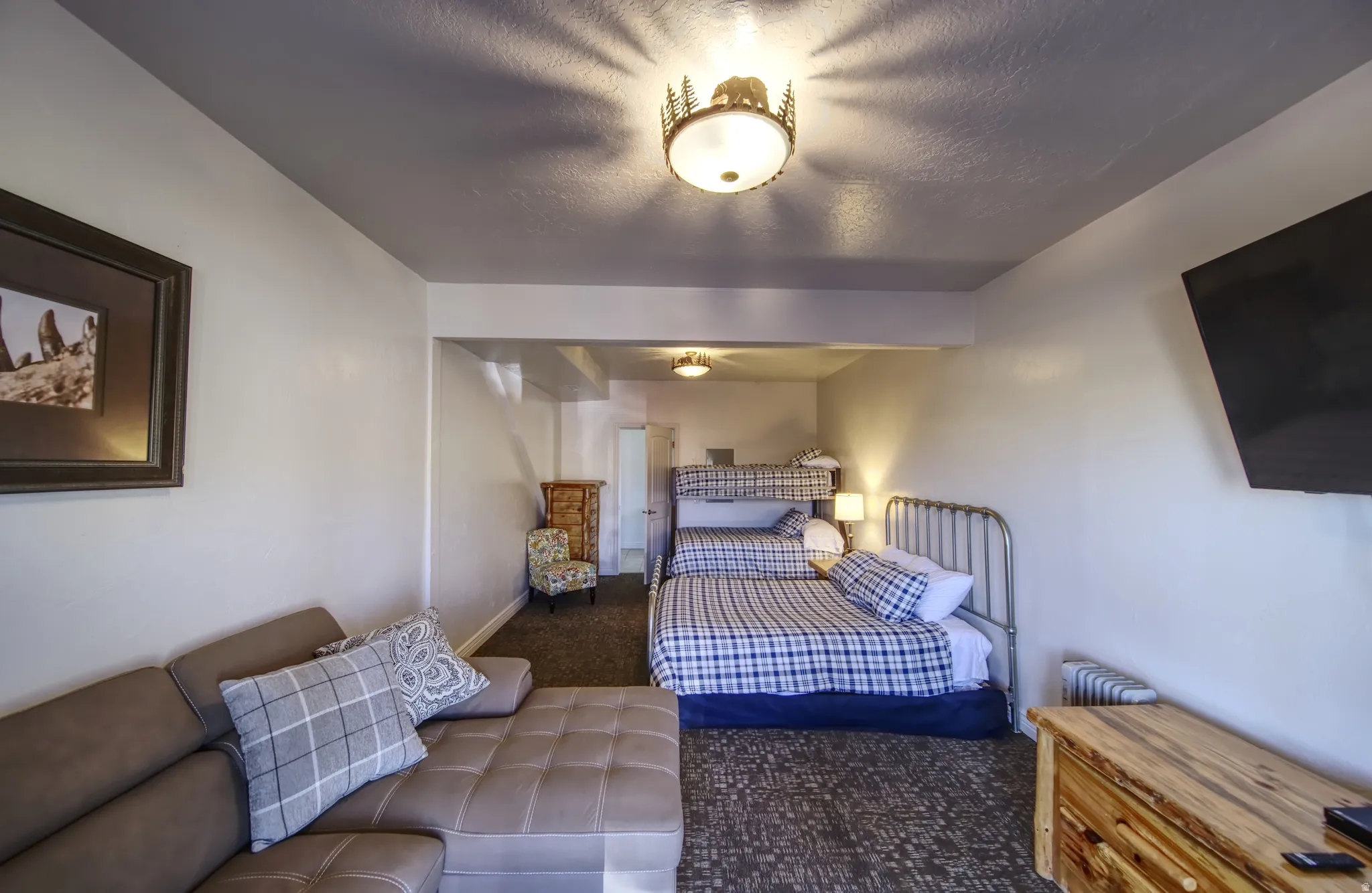 Open-concept space featuring a textured gray ceiling, recessed lighting, and a wall-mounted display