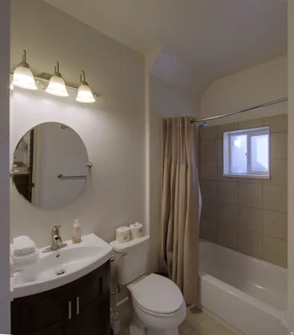 Bathroom featuring a vanity with a dark wood-finish cabinet, white basin, and brushed nickel faucet