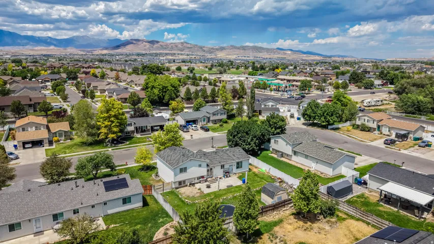 Expansive aerial perspective showcasing a residential neighborhood with distant mountain ranges
